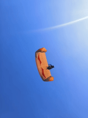 Tandem paragliders fill the sky above Kuta Selatan's coastline