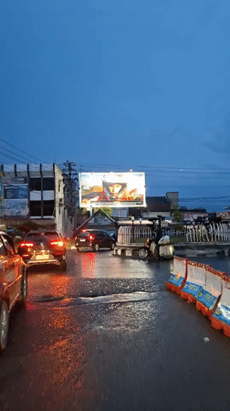 Daily life documented in rain-soaked Lhokseumawe, Indonesia