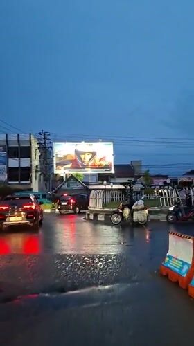 Daily life documented in rain-soaked Lhokseumawe, Indonesia