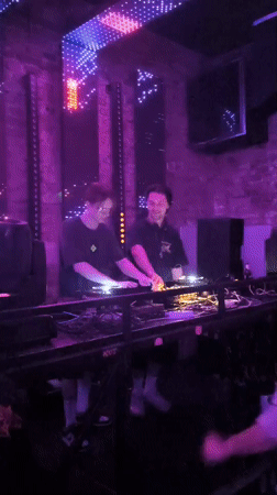 Belgrade club night with DJs, disco ball, and colored lights