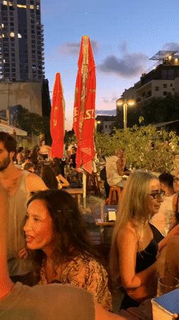 Evening out at a Tel Aviv bar, inside and out