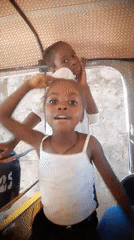 Family travels by tuk-tuk in Jos, Nigeria