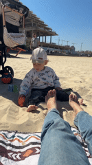 Toddler enjoys sunny morning on Bat Yam beach