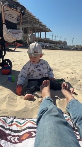 Toddler enjoys sunny morning on Bat Yam beach