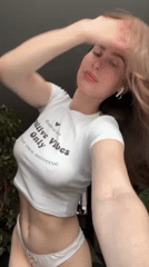 Woman poses in motivational crop top in Krasnoyarsk apartment