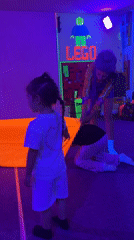 Children's blacklight party documented by witnesses in decorated room