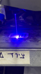 Laser engraver operates on metal tag in Tel Aviv