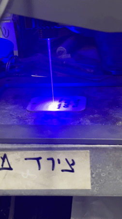 Laser engraver operates on metal tag in Tel Aviv