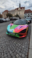 Wrapped McLaren 720S parked on cobblestone streets in Beroun