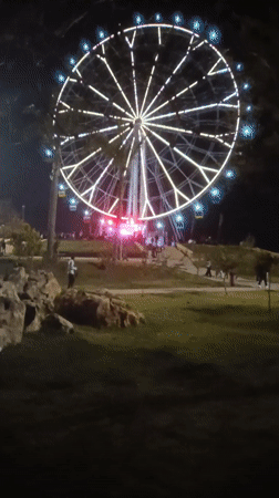 Nighttime Ferris wheel draws visitors in Morocco amusement area