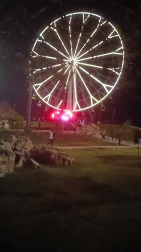 Nighttime Ferris wheel draws visitors in Morocco amusement area