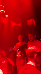 Rose presentation at a red-lit Moscow gathering