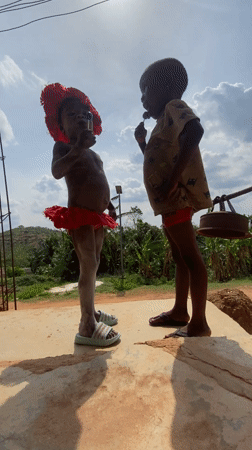 Children celebrate with traditional dress and body paint in Achara