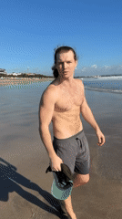 Man with ponytail filmed during beach visit in Kuta