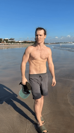 Man with ponytail filmed during beach visit in Kuta