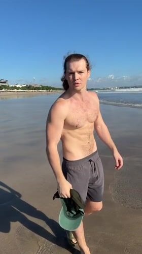 Man with ponytail filmed during beach visit in Kuta