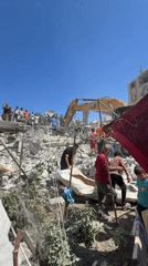 Recovery crews pull bodies from collapsed building in Gaza