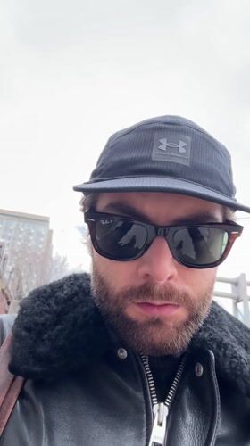 Person takes selfie in Montreal wearing baseball cap and sunglasses