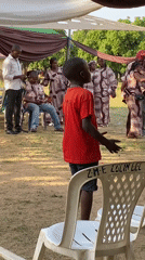 Children dance at outdoor celebration in Bukuru, Nigeria