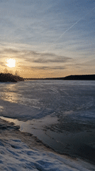 Winter sunset captured over frozen lake in Otchor, Russia