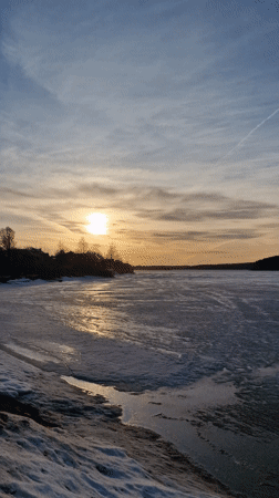 Winter sunset captured over frozen lake in Otchor, Russia