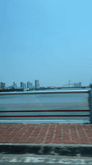 Vehicle crosses bridge in Đà Nẵng at dawn