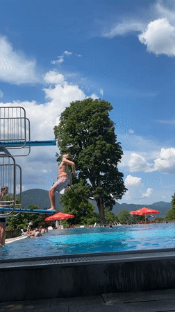 Backflip off the diving board at an Oberammergau outdoor pool