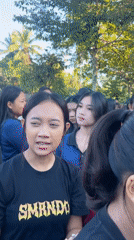 Students gather outdoors in matching attire in Mendoyo, Indonesia