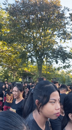 Students gather outdoors in matching attire in Mendoyo, Indonesia