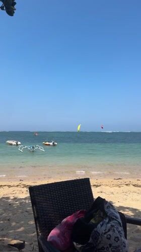 Kiteboarding, boats, and beach life on a Bali morning