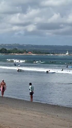 Morning surfing activity observed at Kuta Beach, Indonesia