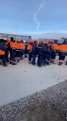 Workers in safety gear gather at Koskolovo worksite