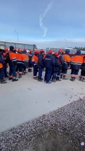 Workers in safety gear gather at Koskolovo worksite