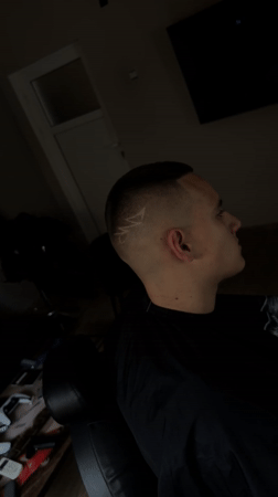 Young man gets stylized haircut at Bulgarian barbershop