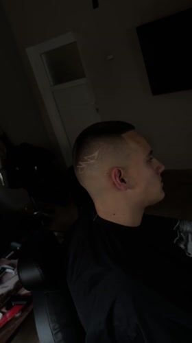 Young man gets stylized haircut at Bulgarian barbershop