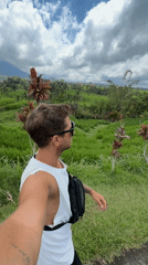 Visitor documents Penebel rice terraces and rural Indonesian landscape