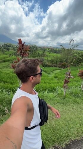 Visitor documents Penebel rice terraces and rural Indonesian landscape