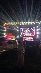 Nighttime event in Slateng with stage, screens, and live production
