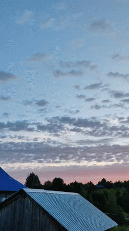 Summer evening in Chukhlem: garden blooms, wooden houses, and a slow sunset