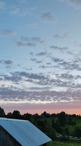 Summer evening in Chukhlem: garden blooms, wooden houses, and a slow sunset