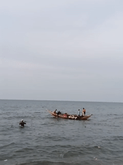Group fishing under overcast skies in Lhokseumawe, Indonesia