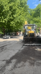 Construction equipment positioned on road under repair