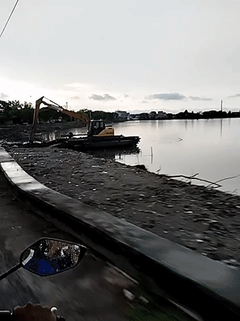 Dredging operations continue at dusk in Lhokseumawe waterway