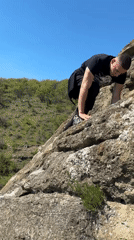 Man poses on rocky cliffs near Goritsa, Bulgaria