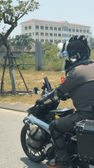 Motorcyclist with spiked helmet rides through Da Nang streets