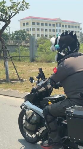 Motorcyclist with spiked helmet rides through Da Nang streets