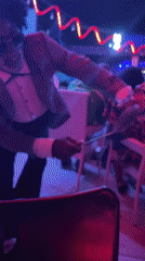 Nightclub scene captured with dancing patrons in colorful lighting