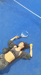 Padel session at a glass-walled court overlooking Bali rice fields