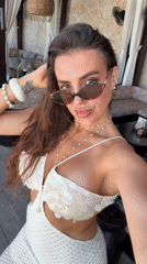 Woman films selfie video session in white dress, Kuta Selatan