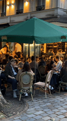 Evening Paris scenes show cafe life, river boat, Notre Dame restoration